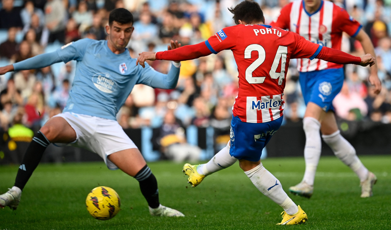 Girona's Spanish forward Cristian Portugues kicks the ball and scores his team's first goal during the Spanish league football match between RC Celta de Vigo and Girona FC at the Balaidos stadium in Vigo on Jan. 28, 2024. (AFP)