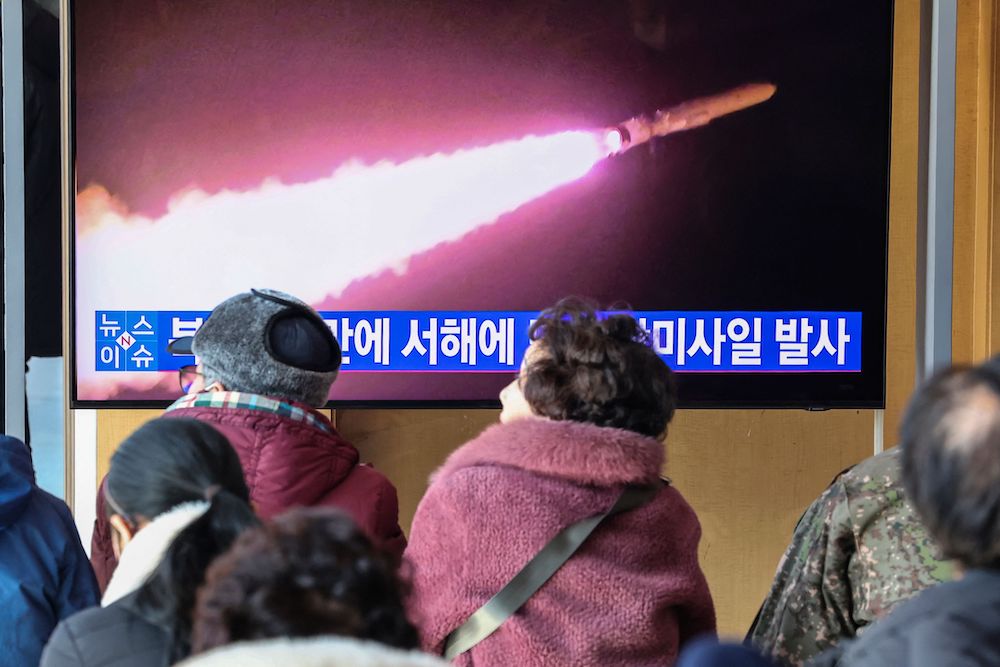 People watch a television screen showing a news broadcast with file footage of a North Korean missile test at a railway station in Seoul on Jan. 30, 2024. (Yonhap/AFP)