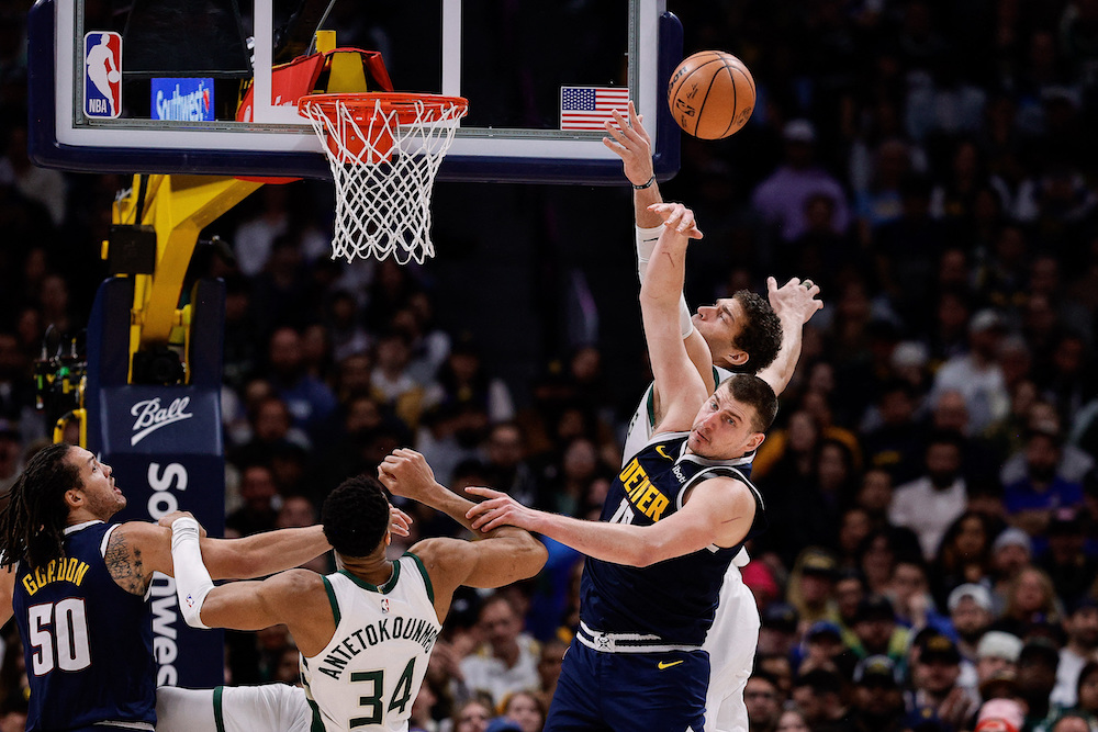 Denver Nuggets’ Nikola Jokic battles for a rebound with Milwaukee Bucks’ Brook Lopez in the fourth quarter of their NBA game at Ball Arena Monday. (USA TODAY Sports)
