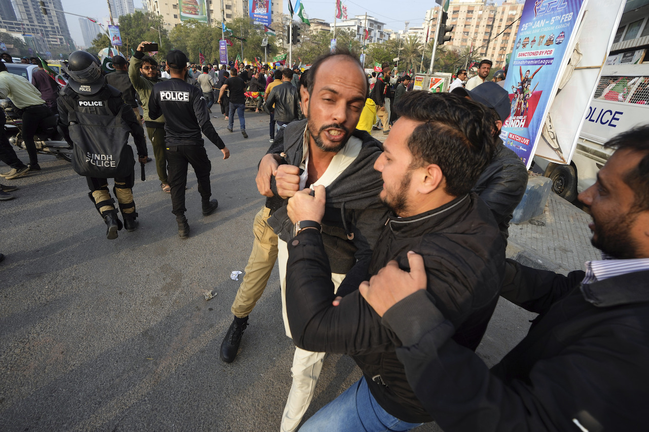 The jail term is the second conviction for former prime minister Imran Khan in recent months, and ensures he will remain in jail, and out of the public spotlight, ahead of next week’s general elections. Above, police detain a supporter of the former leader. (AFP)