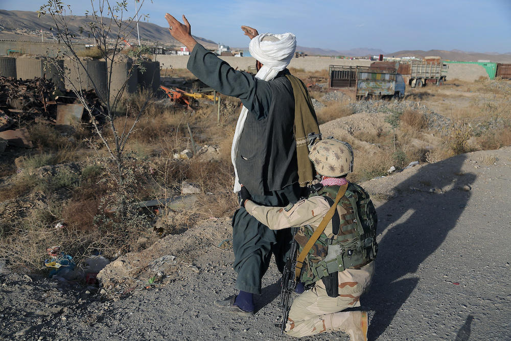 Above, an Afghan special forces soldier searches a passenger at a checkpoint in Ghazni province on Oct. 21, 2015. (AFP)