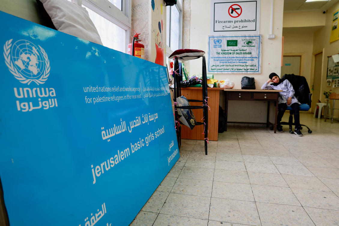 A Palestinian girl waits by the entrance to the UNRWA Jerusalem Girls' School in the Silwan neighbourhood of East Jerusalem, January 30, 2024. (Reuters)