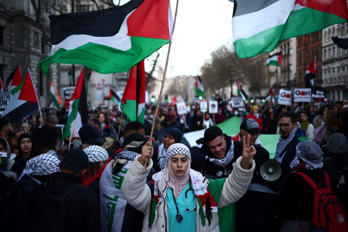 Pro-Palestinian activists and supporters wave flags and carry placards during a National March for Palestine in central London. (File/AFP)
