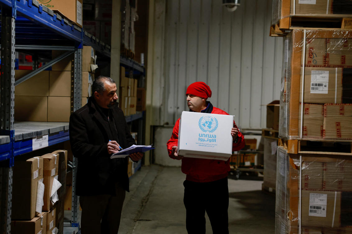 Israeli has accused that some UNRWA staff took part in the Oct. 7 attack by Hamas militants, which prompted some donor countries to cut funding for the agency. Above, UNRWA workers handle boxes of humanitarian aid at their West Bank field office in the Sheikh Jarrah neighborhood of East Jerusalem. (Reuters)