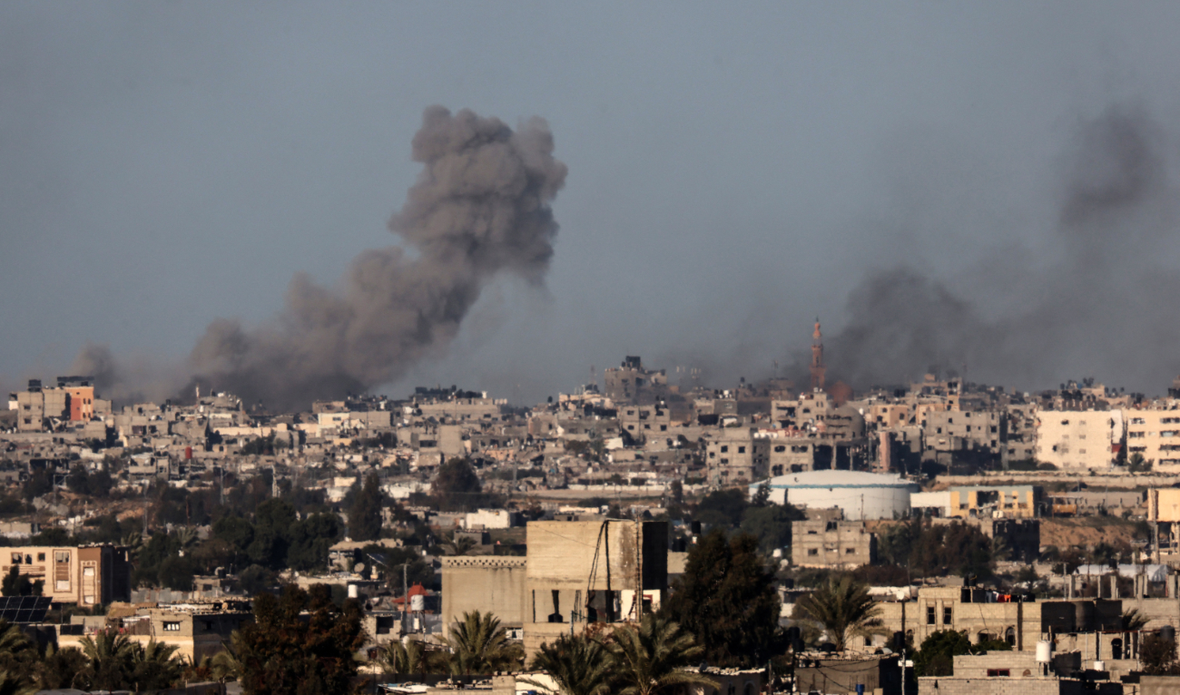 This picture taken from Rafah in the southern Gaza Strip shows smoke rising over buildings in Khan Yunis during Israeli bombardment on January 31, 2024. (AFP)