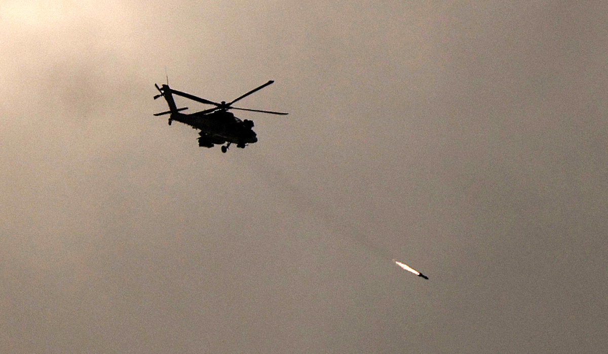 An Israeli military helicopter firing a missile towards Gaza. (AFP)