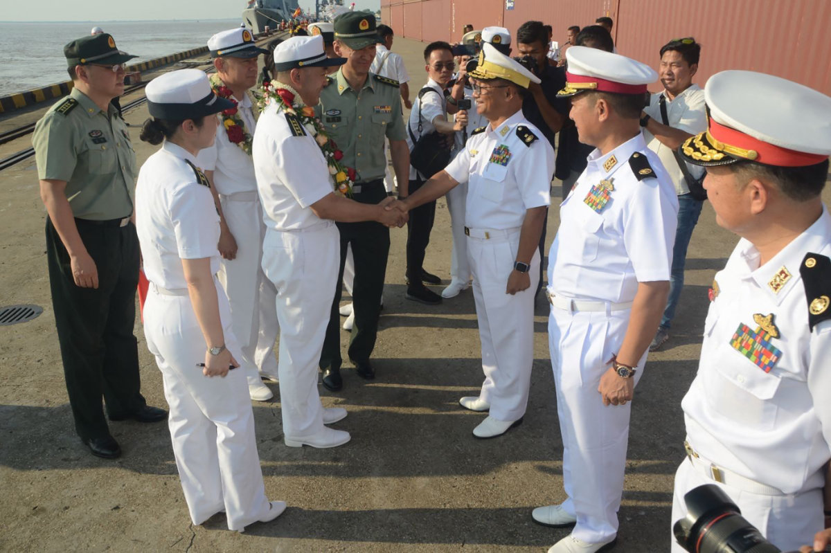 Myanmar navy officials (R) welcome visiting Chinese navy sailors at Thilawa port in Yangon on Nov. 27, 2023. (Handout via AFP)