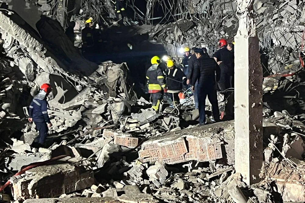 Firemen and security staff inspect the rubble of a building destroyed after a missile attack by Iran's Islamic Revolutionary Guard Corps (IRGC), Erbil, autonomous Kurdish region, Iraq, Jan. 16, 2024. (AFP)