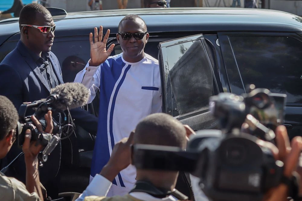 Succes Masra (C) waves while arriving at a polling station to cast his vote during the constitutional referendum in N’Djamena. (File/AFP)