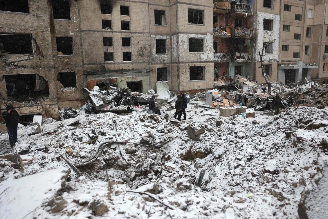 Police officers and local residents inspect damage outside a destroyed high-rise building following a Russian missile attack in central Kyiv amid the Russian invasion of Ukraine. (AFP)