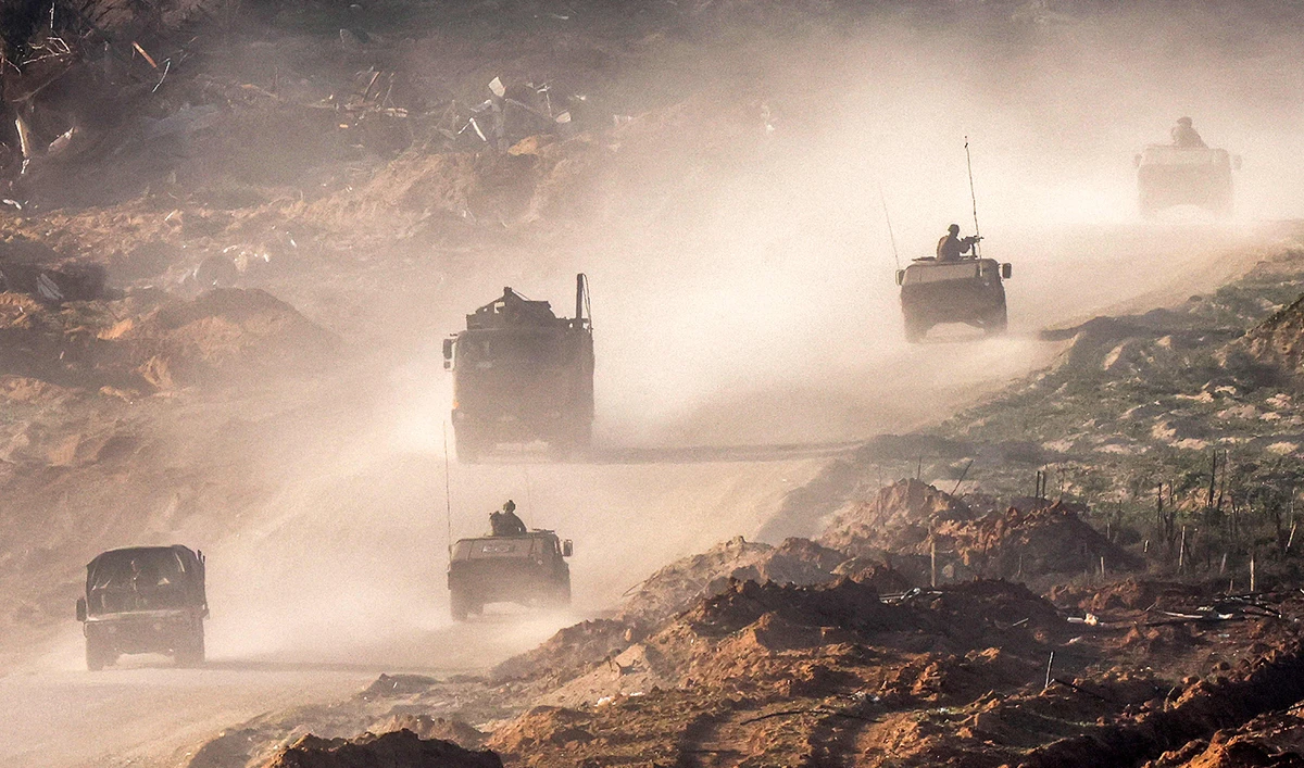 Israeli army humvees and vehicles move along a dirt road in the Gaza Strip near a position along the border with southern Israel on January 4, 2024. (AFP)