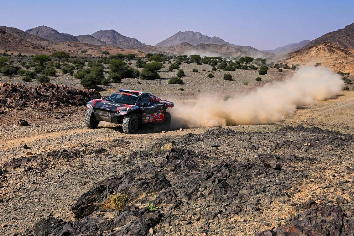 Audi’s French driver Stephane Peterhansel and his French co-driver Edouard Boulanger steer their car during Stage 2 of the Dakar Rally 2024, between Al-Henakiyah and Al-Duwadimi, Saudi Arabia, on Jan. 7, 2024. (AFP)