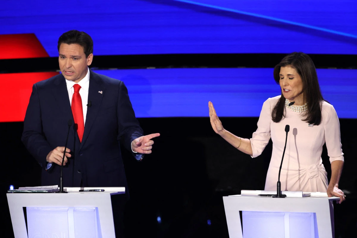Florida Governor Ron DeSantis and former US Ambassador to the United Nations Nikki Haley discuss an issue as they participate in the Republican candidates' presidential debate hosted by CNN at Drake University in Des Moines, Iowa, onJanuary 10, 2024. (REUTERS)
