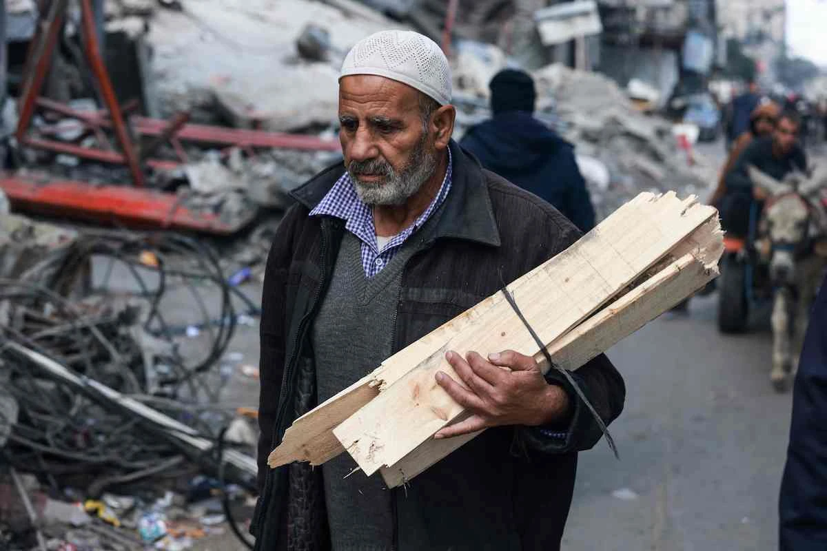 A man carries firewood in Rafah in the southern Gaza Strip on Jan. 14, 2024, as the ongoing war between Israel and Hamas enters its 100th day. (AFP)