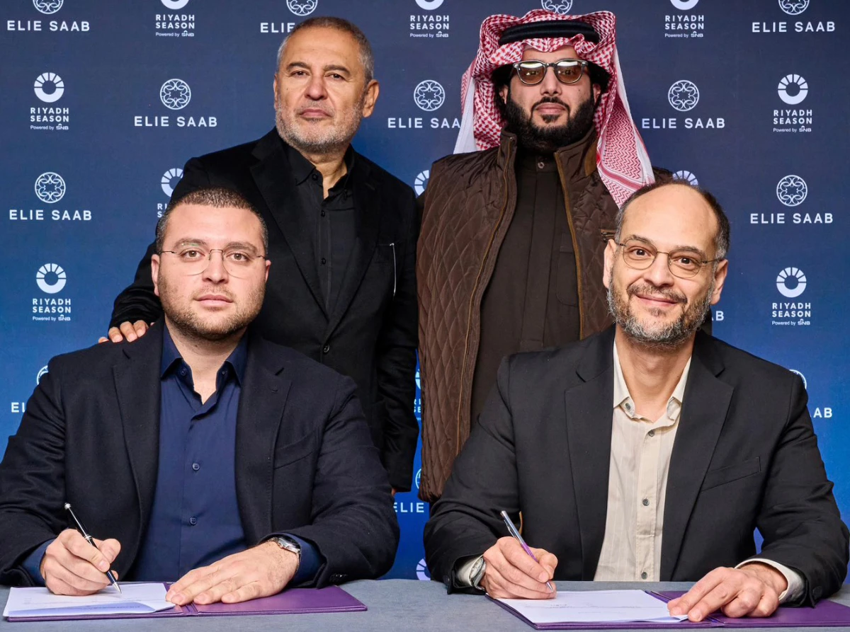 Faisal Bafarat, right, and Elie Saab Jr. sign an MoU in London with Turki Al-Sheikh and Elie Saab present. (Supplied)