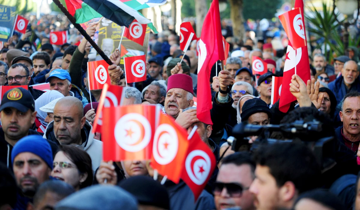 People commemorate the 13th anniversary of the Tunisian uprising in Avenue Habib Bourguiba, Tunis, Sunday, Jan. 14, 2024. (AP)