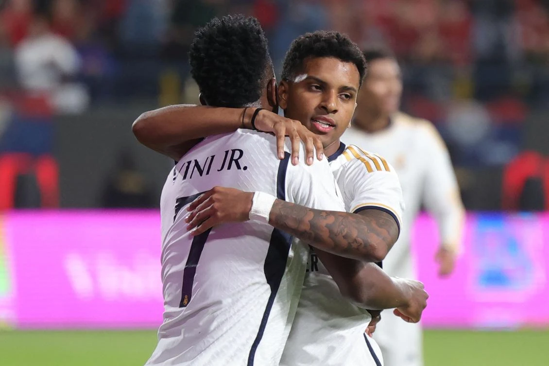 Real Madrid's Brazilian forward Vinicius Junior congratulates teammate Brazilian forward Rodrygo after the latter scored their fourth goal during the Spanish Super Cup final between Real Madrid and Barcelona on Jan. 14, 2024. (AFP)