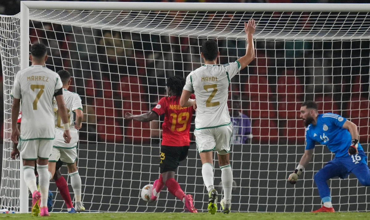 Angola's Mabululu, 3rd left, scores his side's goal after a rebound from a penalty kick during the African Cup of Nations Group D soccer match between Algeria and Angola in Bouake, Ivory Coast, Monday. (AP)