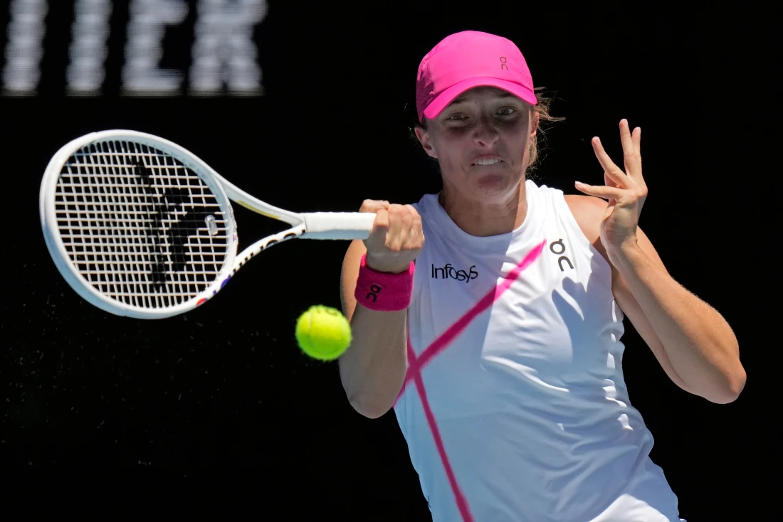 Iga Swiatek of Poland Sofia plays a forehand return to Sofia Kenin of the US during their first round match at the Australian Open tennis championships at Melbourne Park, Melbourne, Australia. (AP)