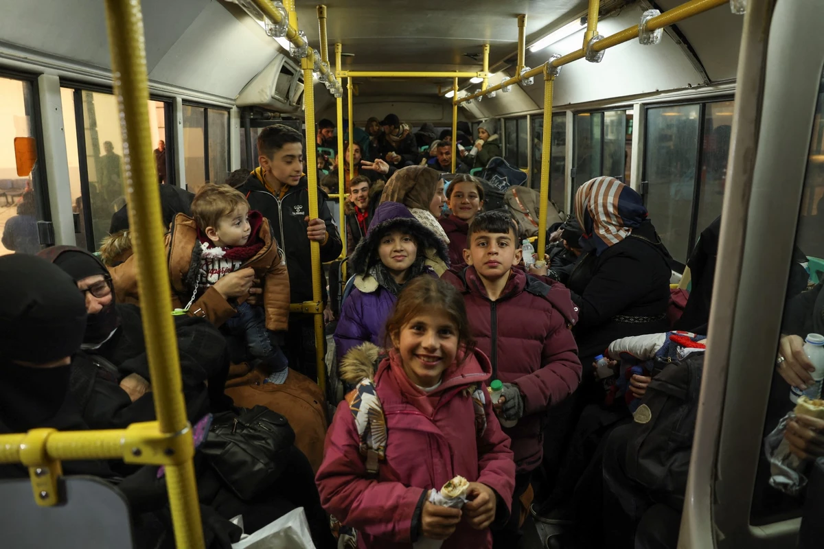 Syrian refugees living in Turkey take a bus through the northern Bab al-Hawa border crossing, on February 17, 2023, as they return to Syria in the aftermath of a deadly earthquake. (File/AFP)