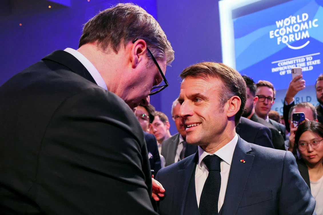 Serbia's President Aleksandar Vucic speaks with France's President Emmanuel Macron, as they attend the 54th annual meeting of the World Economic Forum, in Davos, Switzerland, January 17, 2024. (Reuters)