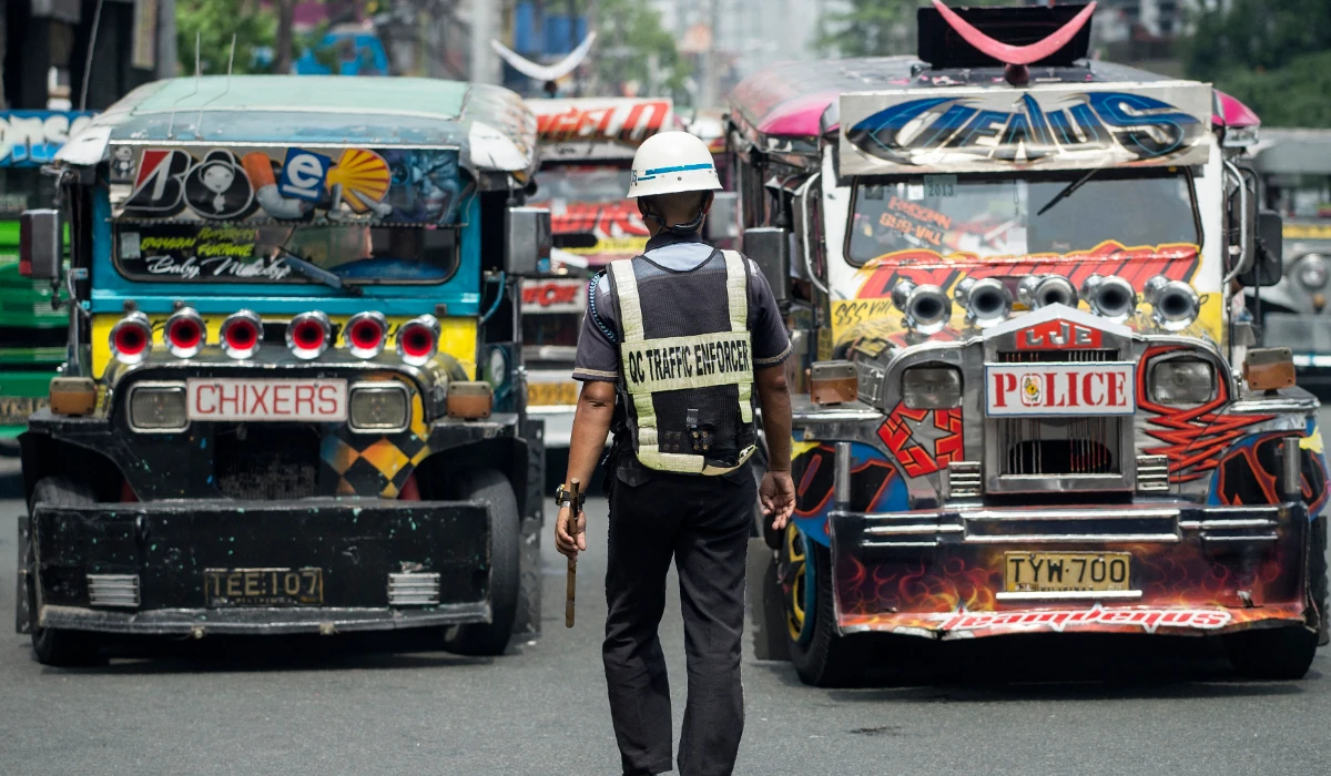 Jeepneys are seen as an enforcer manages traffic at a busy street in Manila, Philippines on May 30, 2017. (AFP)