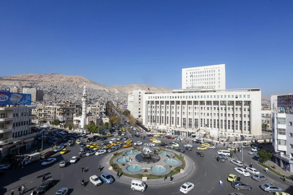 This picture shows a general view of Sabaa Bahrat Square with the central bank of Syria building (R) and Mount Qasioun seen in the background in Syria's capital Damascus on January 9, 2024. (AFP)