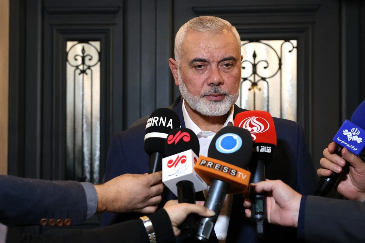 File Photo Qatar-based Hamas leader Ismail Haniyeh speaking to journalists (AFP)