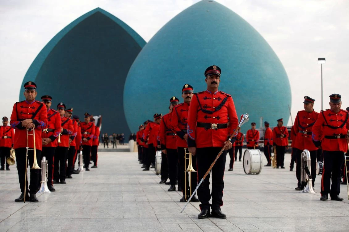 Members of the Iraqi Honor Guard stand at attention during a solemn funeral ceremony for the 41 victims from the Yazidi minority, who were executed by Daesh militants in 2014, at the Al-Shaheed Monument (aka the Martyr's Memorial) in Baghdad, on January 22, 2024.(AFP)