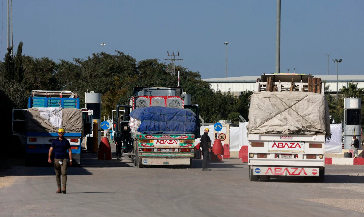 Egyptian trucks carrying humanitarian aid undergo security at the Israeli side of the Kerem Shalom border crossing before entering the southern Gaza Strip. (AFP)