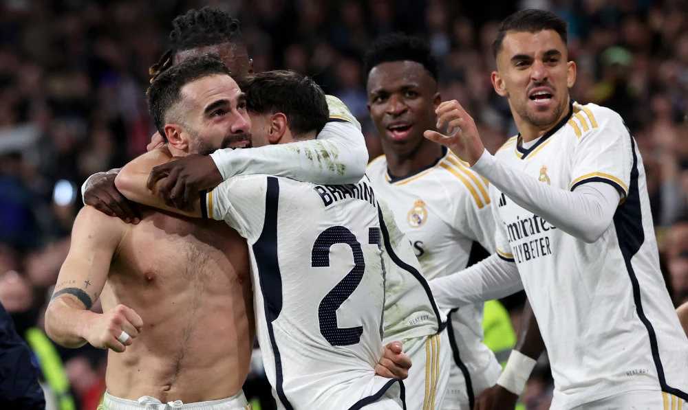 Real Madrid's Spanish defender Dani Carvajal (L) celebrates victory with teammates at the end of the Spanish League football match between Real Madrid CF and UD Almeria at the Santiago Bernabeu stadium in Madrid on Jan. 21, 2024. Real Madrid won 3-2. (AFP)