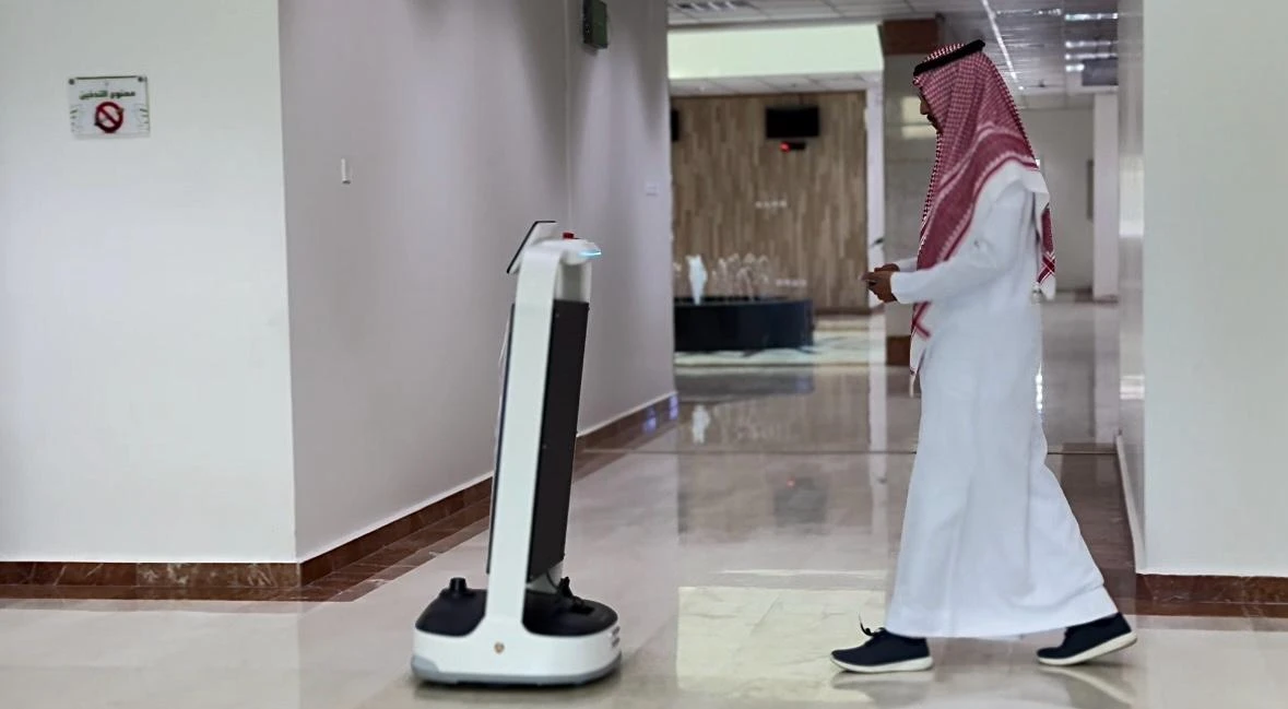 A man approaches a robot through which Bisha Municipality introduced on Monday, Jan. 22. (Supplied)