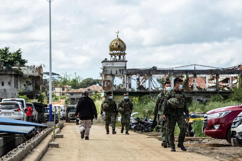 Militant attacks on buses, Catholic churches and public markets have been a feature of decades-long unrest in the south. Above, Philippine soldiers walk past ruins of a mosque which was destroyed in 2017 when Daesh-inspired Muslim militants laid siege to the southern city of Marawi. (AFP)