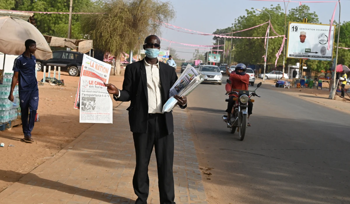 A man sells local newspapers in a street in Niamey, Niger, on December 28, 2020, a day after Niger's general elections. (AFP)