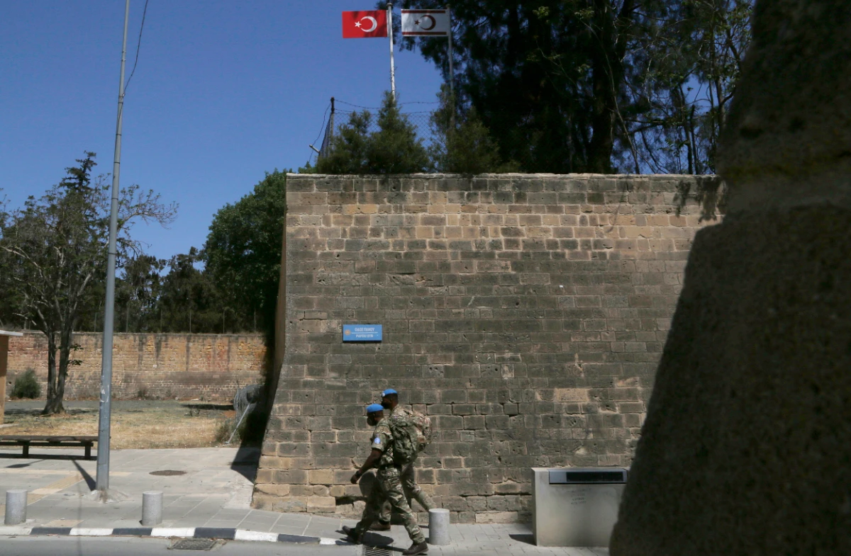 UN peacekeepers walk by the Venice wall at the medieval core across the U.N buffer zone, in the divided capital Nicosia, Cyprus, Monday, April 26, 2021. (AP)