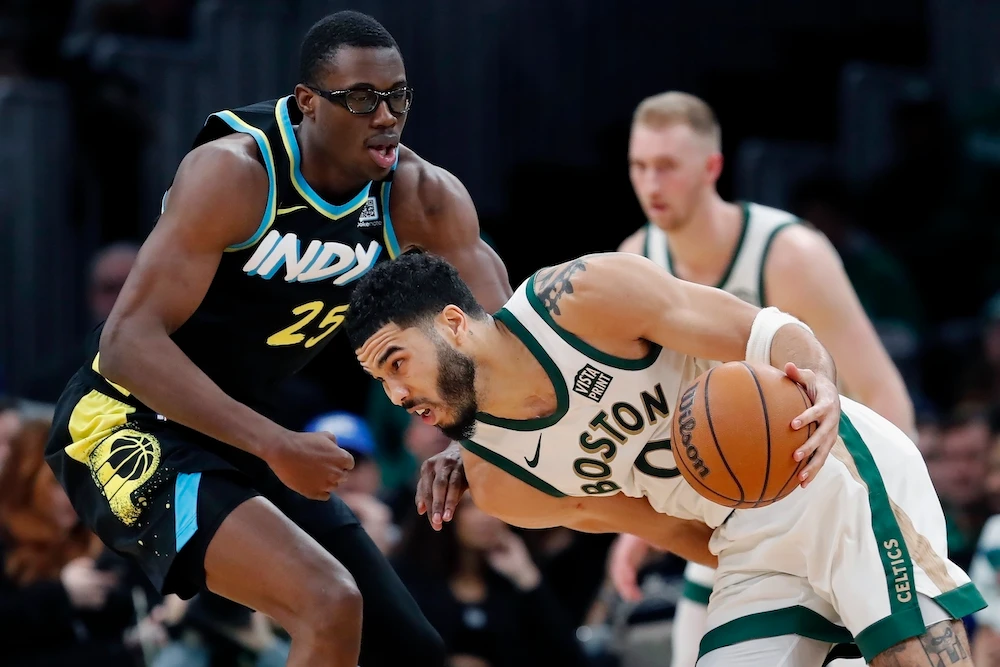 Boston Celtics forward Jayson Tatum drives against Indiana Pacers’ Jalen Smith during the second half of an NBA basketball game Tuesday in Boston. (AP)