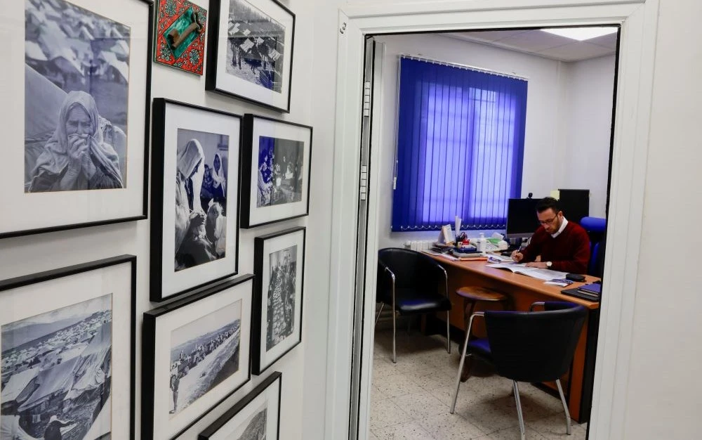 An UNRWA worker sits at his desk in the West Bank field office of UNRWA, in the Sheikh Jarrah neighborhood of East Jerusalem, Jan. 30, 2024. (Reuters)