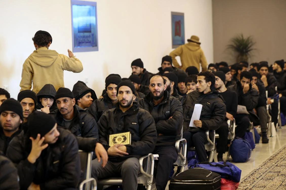 Illegal migrants from Egypt sit in a waiting room during a deportation operation in the Libyan capital Tripoli on Jan. 31, 2024. (AFP)