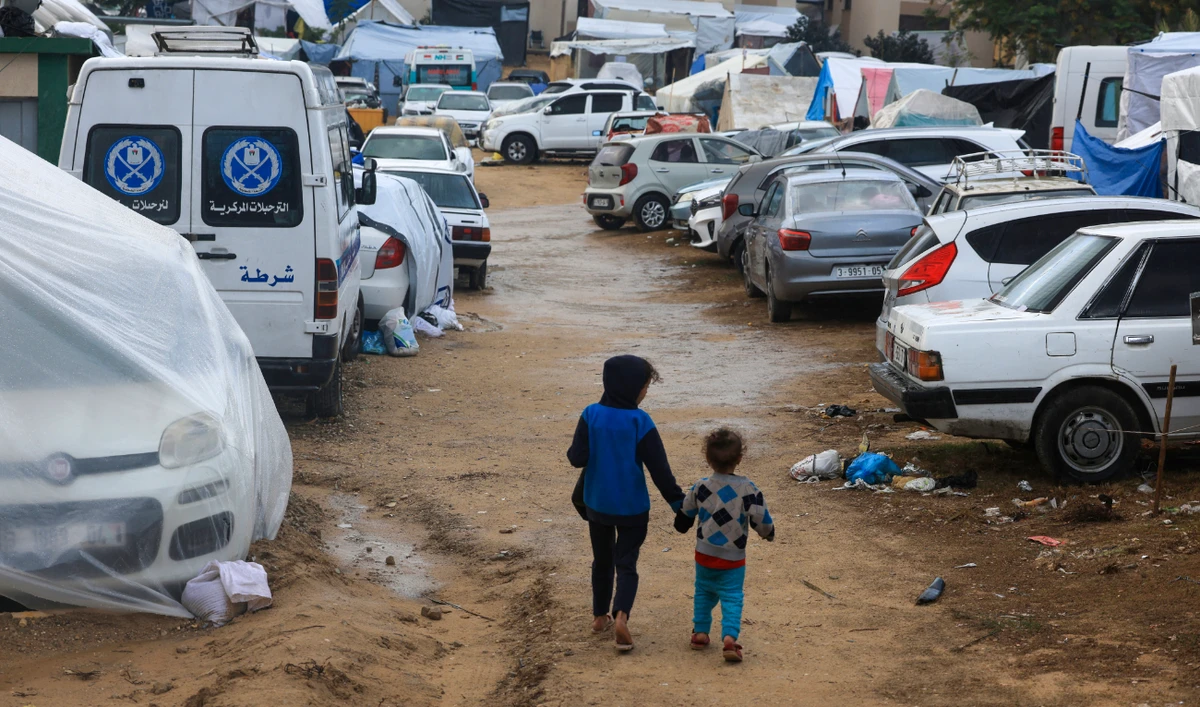 Displaced Palestinian children who fled the northern Gaza Strip due to Israeli bombardment, walk on the grounds of the Nasser Hospital where they are sheltering in Khan Yunis on the southern Gaza Strip on November 20, 2023. (AFP/File)