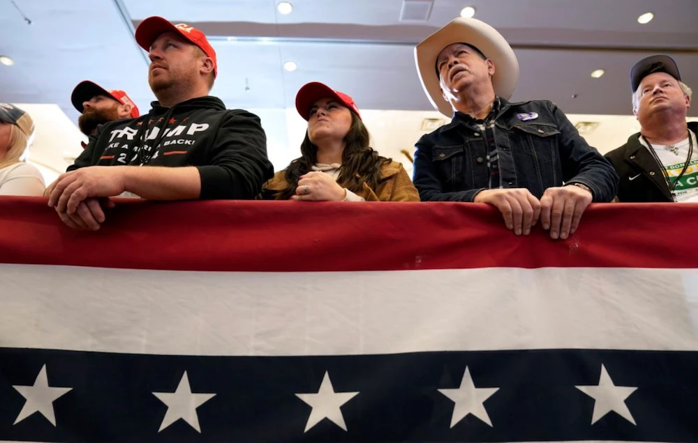 Audience members listen to former President Donald Trump speak during a commit to caucus rally on Dec. 13 in Iowa. (AP)