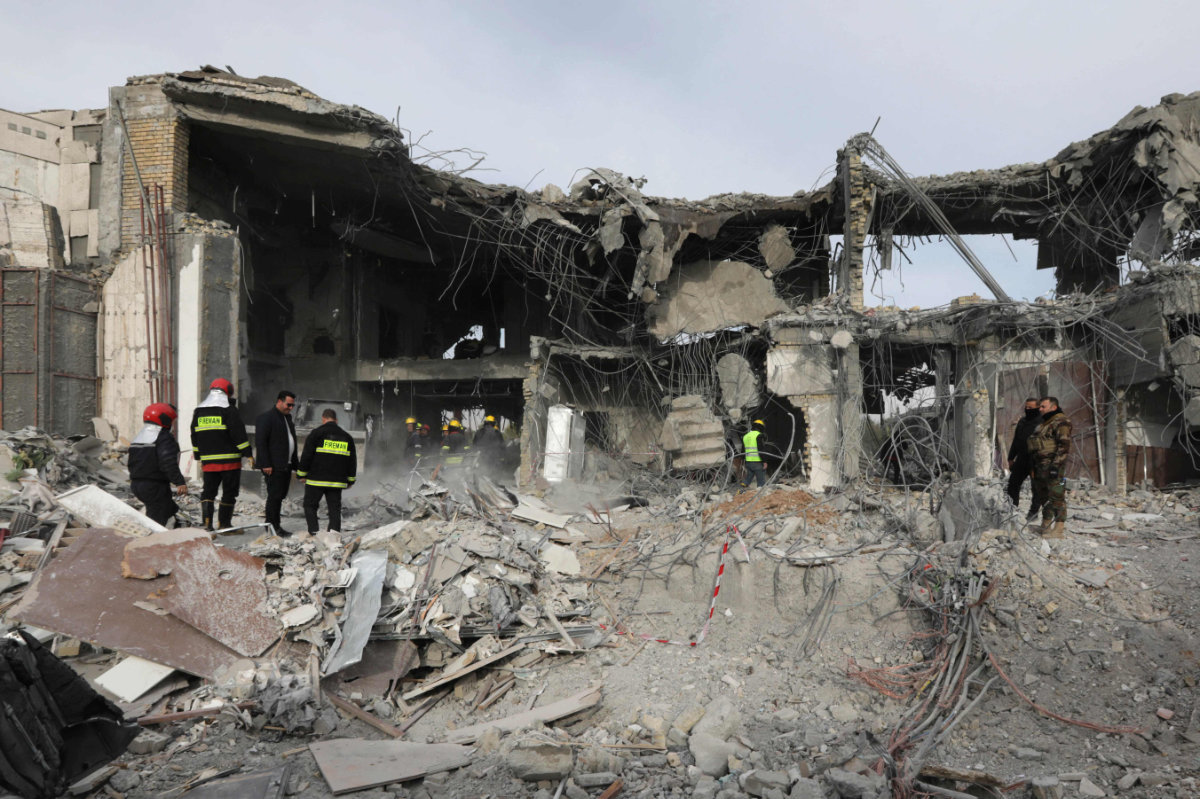 Iraqi rescuers search a building destroyed in an Iranian missile strike in Irbil, Kurdistan region, last week. (AFP)