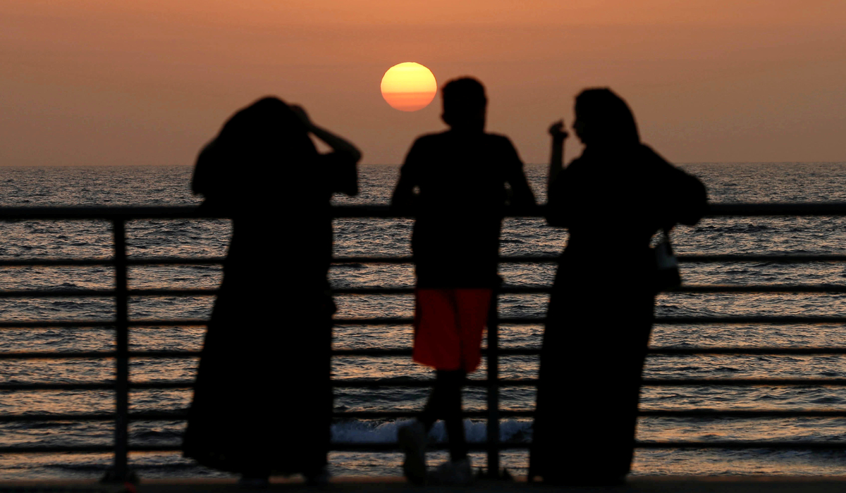 People stand on the corniche at sunset in Jeddah, Saudi Arabia March 8, 2018. (REUTERS)