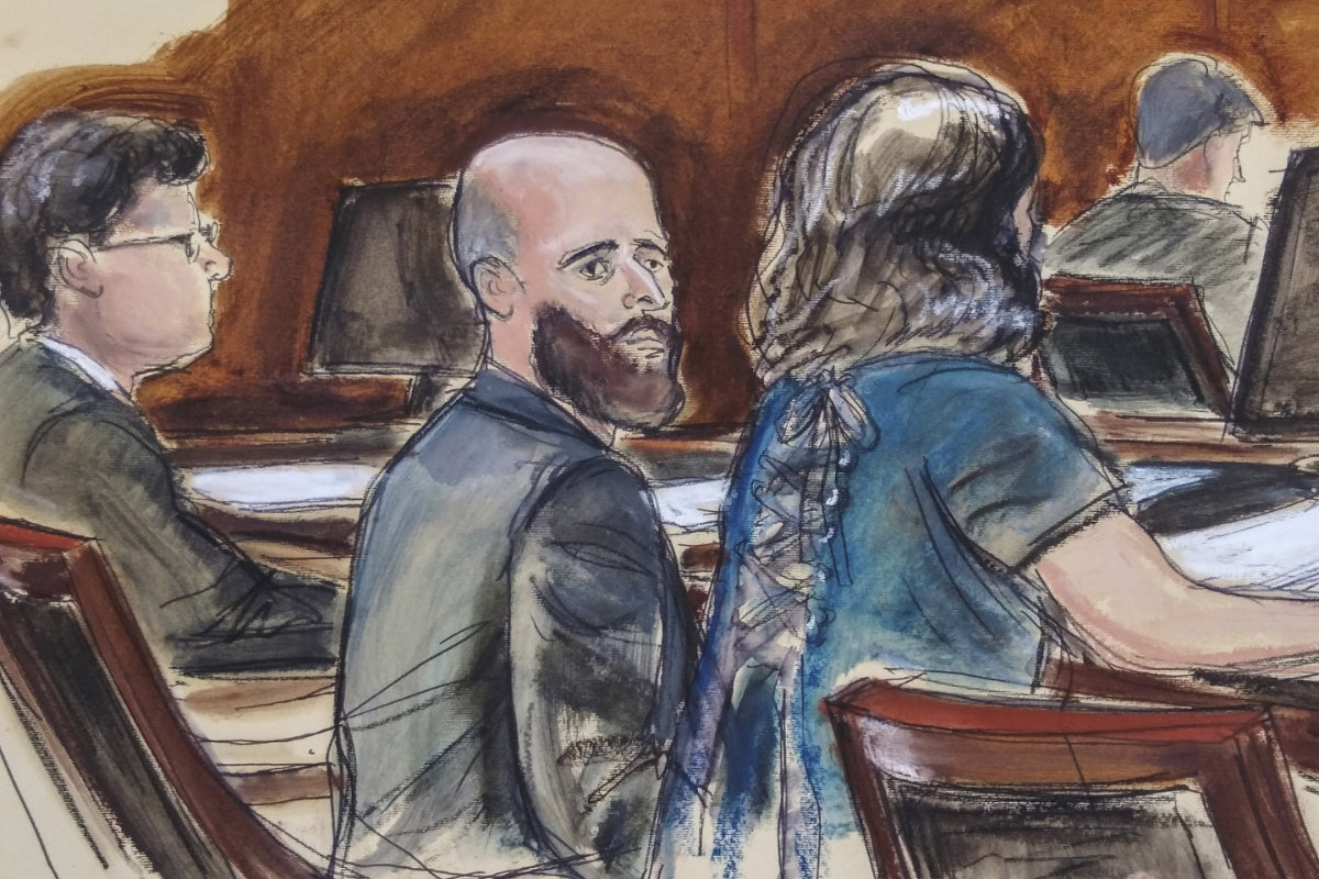 In this courtroom sketch, Joshua Schulte, center, is seated at the defense table flanked by his attorneys during jury deliberations on March 4, 2020, in New York. (Elizabeth Williams via AP)