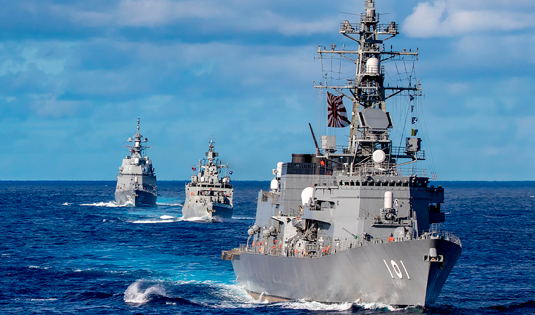 In this photo released by Defense Visual Information Distribution Service, ships from Japan Maritime Self-Defense Force and Indian Navy sail in formation with Royal Australian Navy HMAS Warramunga and Arleigh Burke-class guided-missile destroyer USS Barry (DDG 52) during MALABAR 2021 on August 27, 2021. (U.S. Navy via AP)