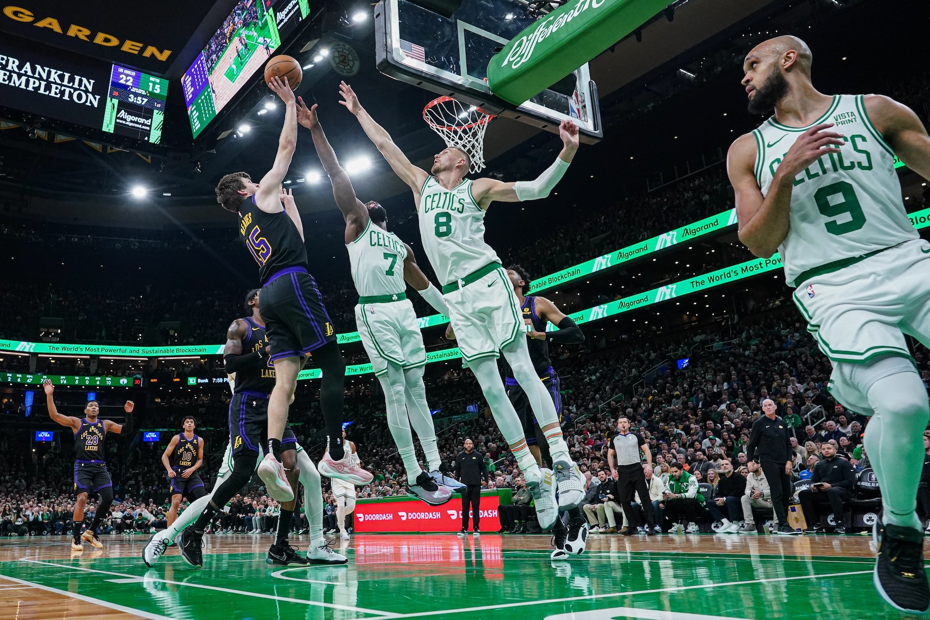 Los Angeles Lakers guard Austin Reaves shoots against Boston Celtics center Kristaps Porzingis (8) and guard Jaylen Brown (7) in the first half of an NBA game at TD Garden Thursday. (USA TODAY Sports)