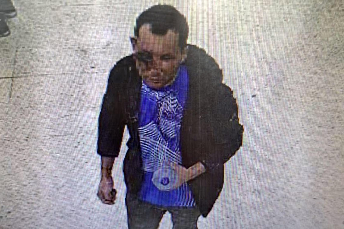 A handout CCTV grab released by Britain's Metropolitan Police in London on February 1, 2024 shows Abdul Shokoor Ezedi, taken in a Tesco store in north London late on January 31, 2024, which appears to show severe damage to his face.(AFP)