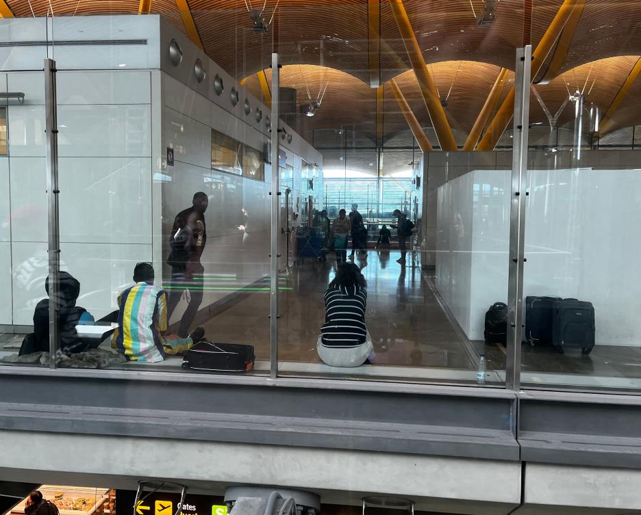 Migrants sit as they wait in the transit area of the Madrid Barajas airport terminal on February 1, 2024. (AFP)