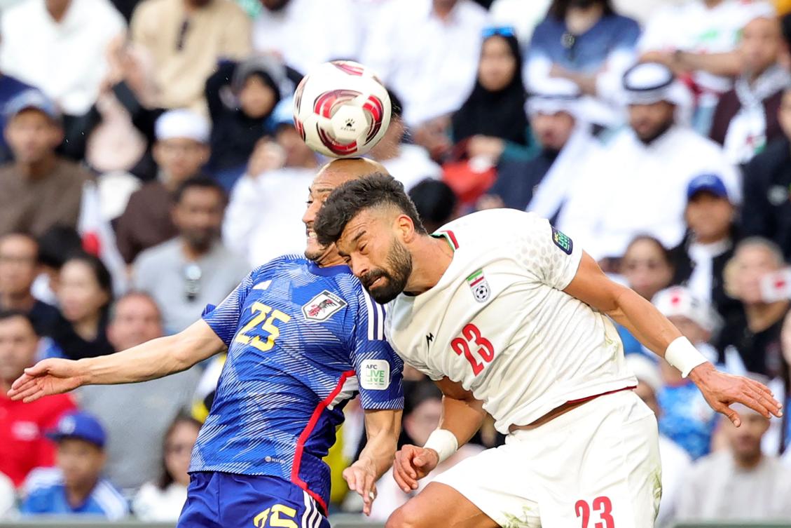 Japan's forward Daizen Maeda heads the ball past Iran's defender Ramin Rezaeian during their Qatar 2023 AFC Asian Cup quarter-final match at Education City Stadium in al-Rayyan, Doha, on Feb. 3, 2024. (AFP)
