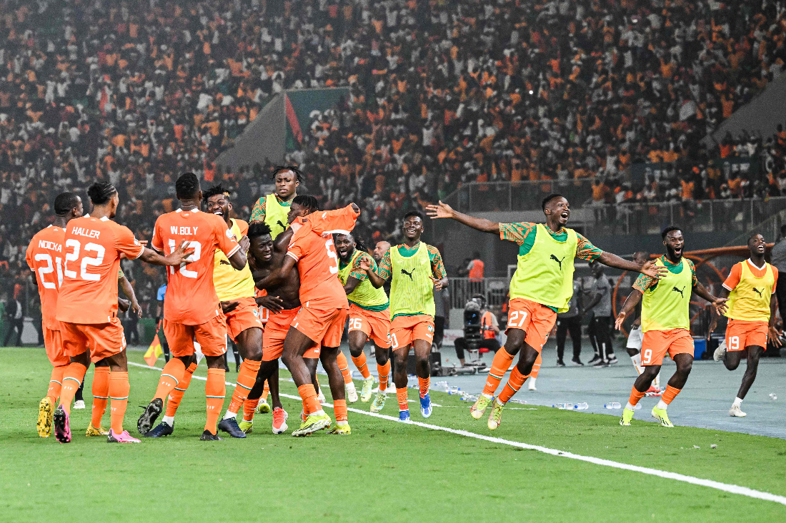 Ivory Coast's forward Oumar Diakite (C) takes his jersey off as he celebrates with teammates after scoring his team's second goal during the Africa Cup of Nations (CAN) 2024 quarterfinal between Mali and Ivory Coast. (AFP)