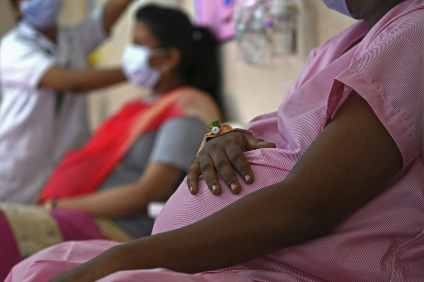 In this file photo, pregnant women wait in line for a vaccine in Chennai, India, on July 5, 2021. (AFP)